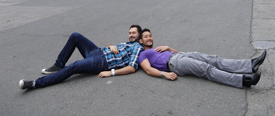 Two Men Lying on Street