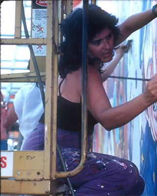 Woman painting a mural